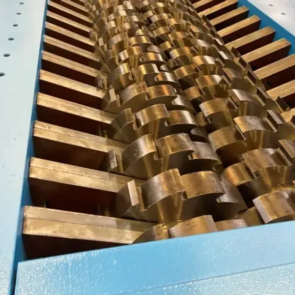 A closeup of the teeth inside of the industrial shredder