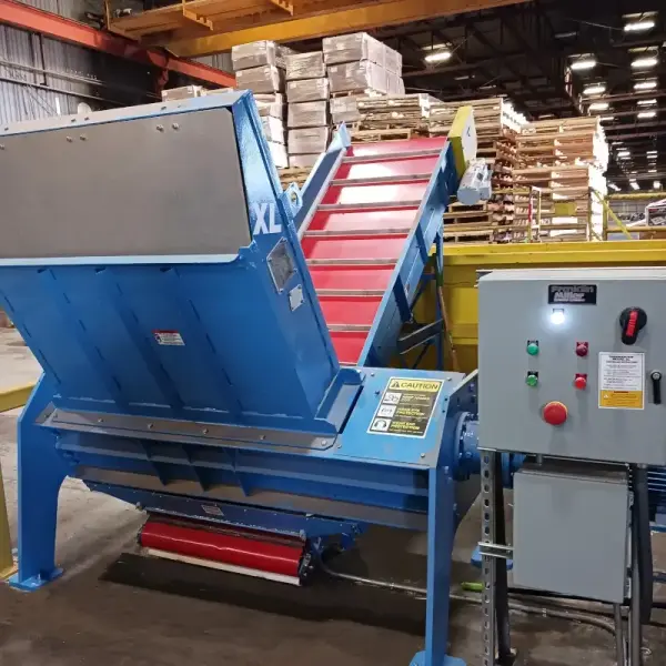 An industrial shredder sitting in the middle of a warehouse