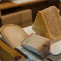 Three pieces of a cheese wheel on the table