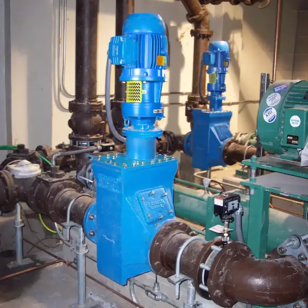 A shredder installed inline to shred sludge