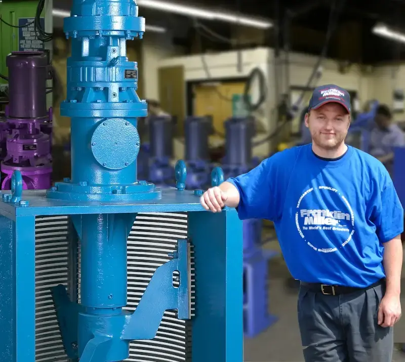 DIMMINUTOR comminutor beside a Franklin Miller employee for scale