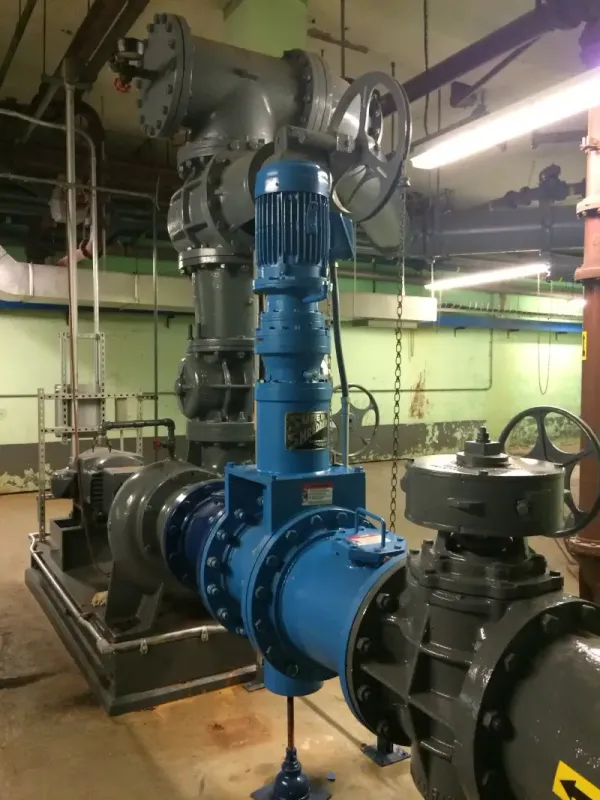 A shredder installed inline to shred sludge