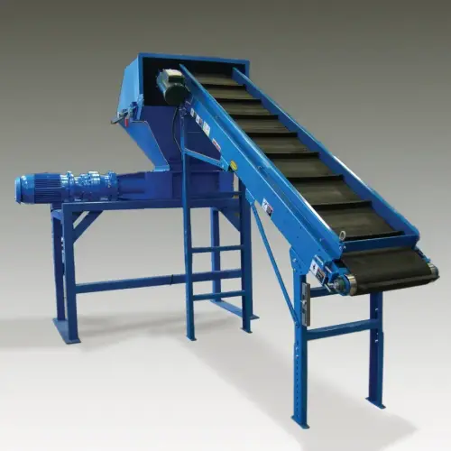 An industrial shredder with a conveyor attachement