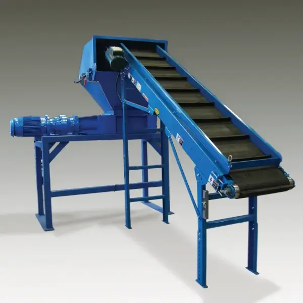 A large industrial shredder with a conveyor attachment