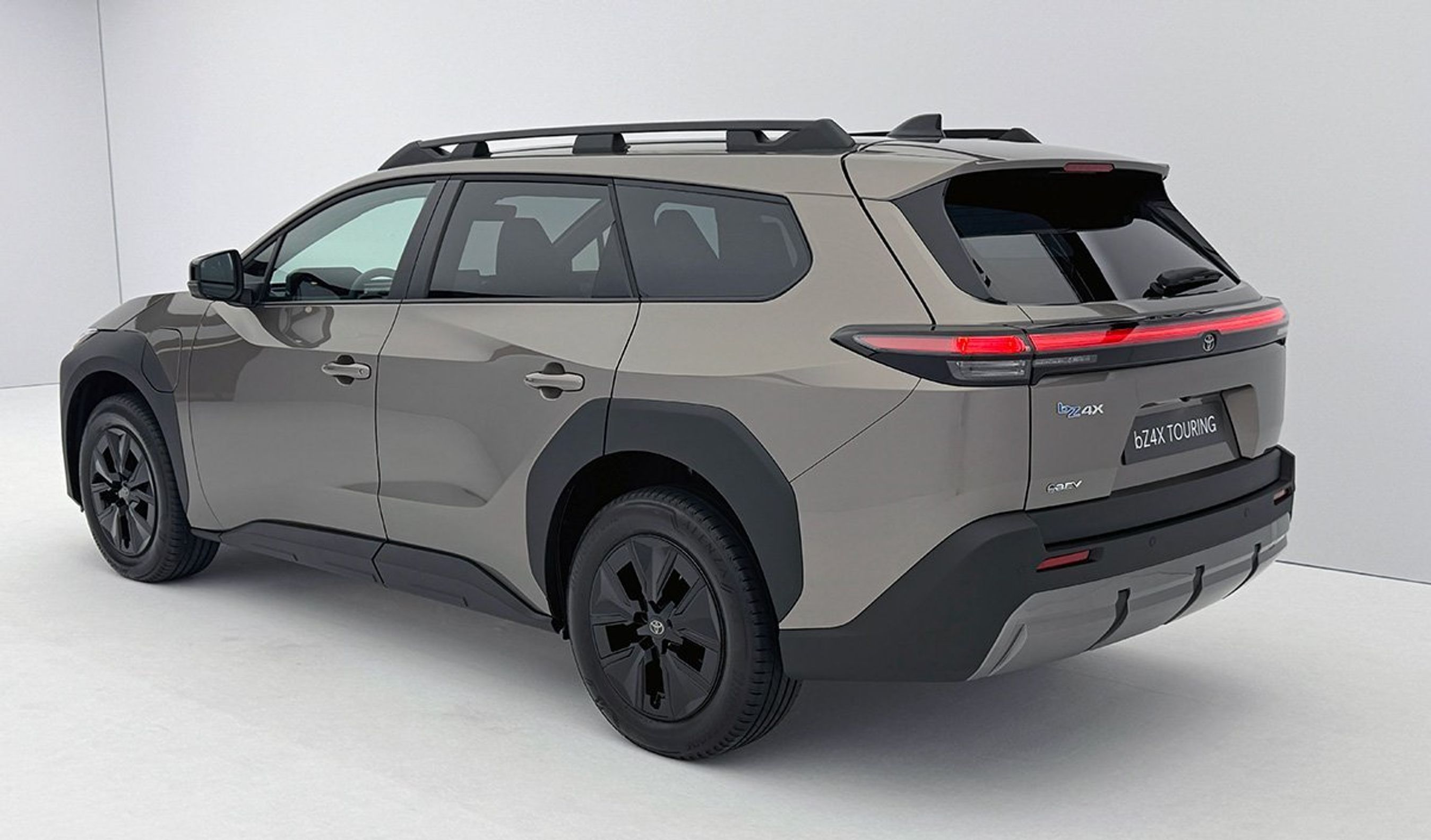 Bronzefarvet Toyota bZ4X skråt bagfra.