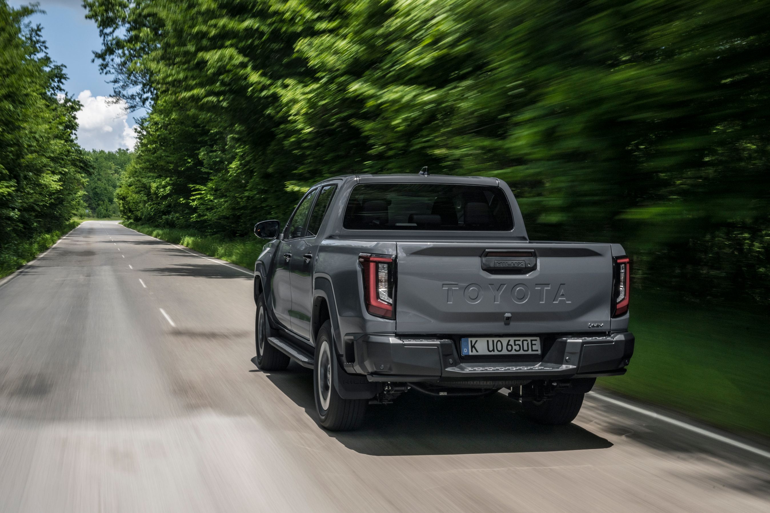 Toyota Hilux set bagfra, mens den kører ud ad skovvej