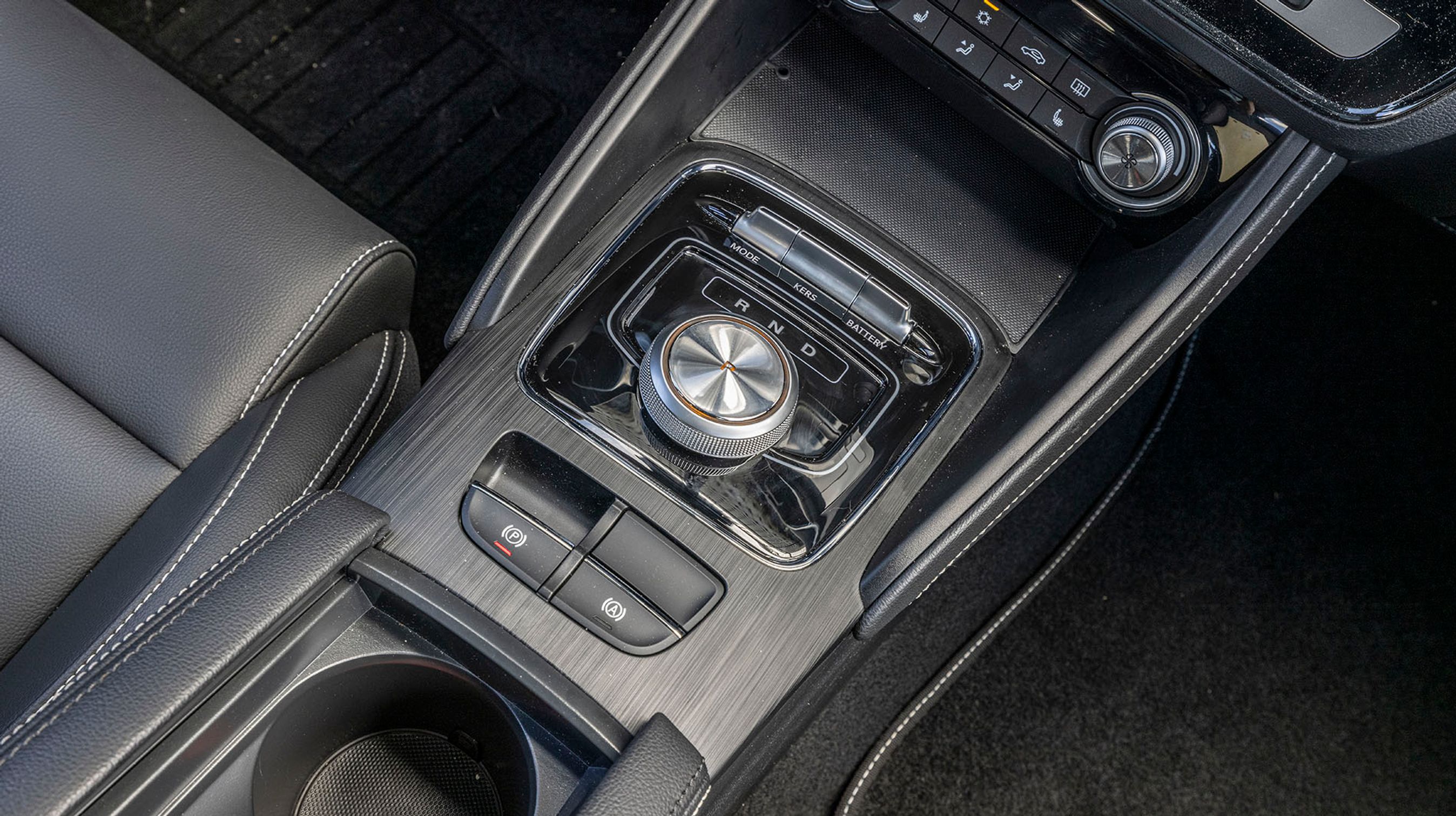 Drejeknappen mellem forsæderne styrer kørselsretningen, og det fungerer glimrende. Den går selv i P, når man slukker bilen.