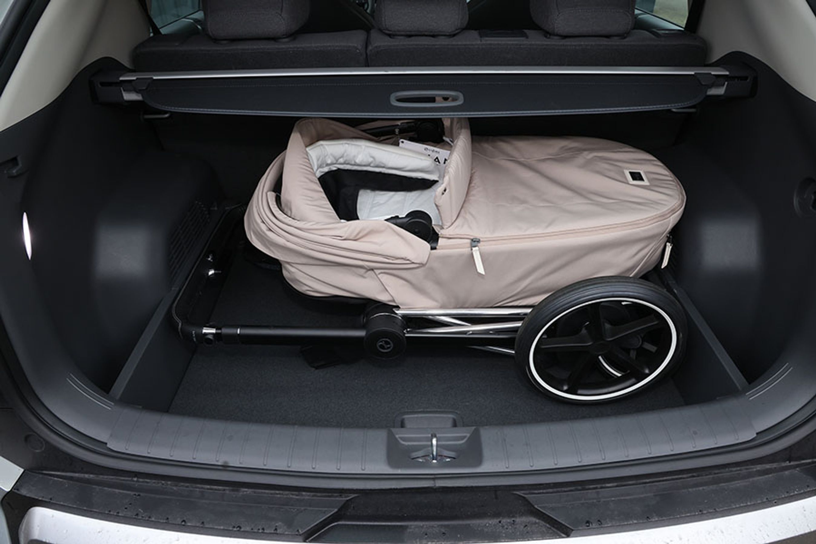 barnevogn ligger i et bagagerum på en bil