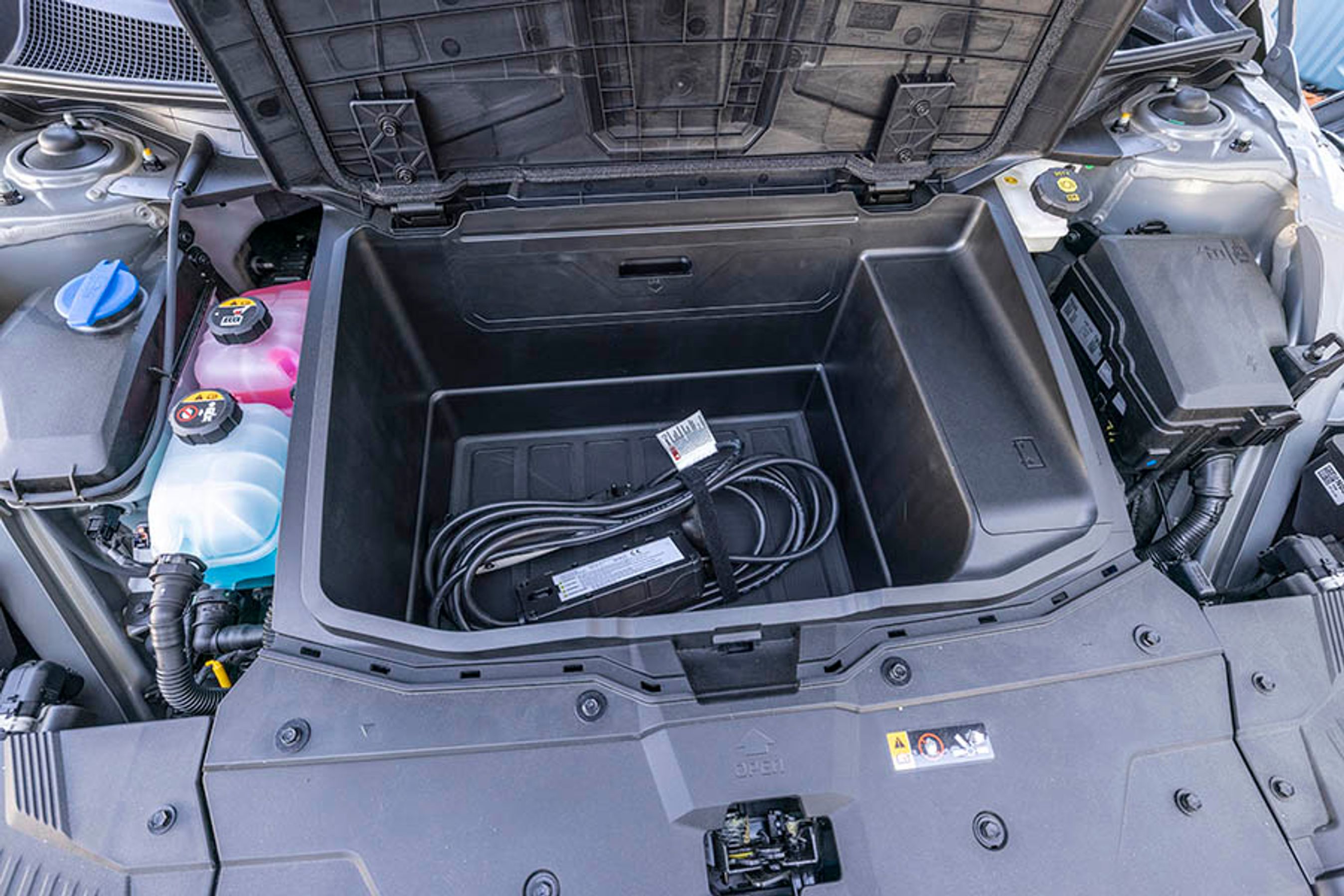 Fortil er der et ret stort rum til ladekabler og nødlader. De er lette at få fat i, når bagagerummet er fyldt.