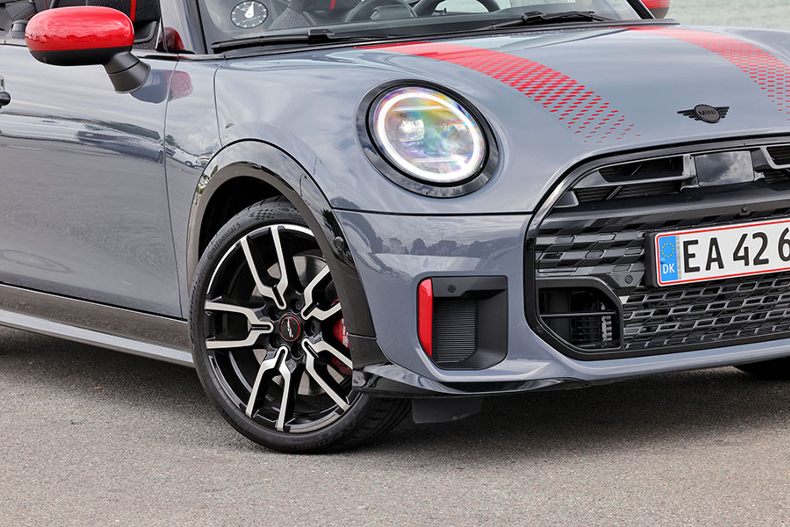 Som altid hos Mini kan man vælge mellem et hav af farvekombinationer, når man skal bestille sin bil. Her er der sorte kontraster ved skærme, grill og lygter, mens røde detaljer dukker op ved sidespejle, luftindtag og ved stafferingen på motorhjelmen. På den måde er der ikke mange udgaver af Mini Cabriolet, der er ens.