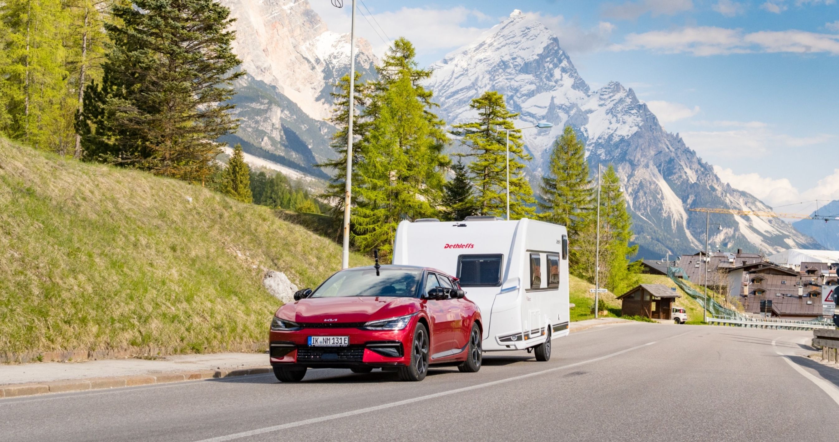 Elbil trækker campingvogn i bjerglandskab