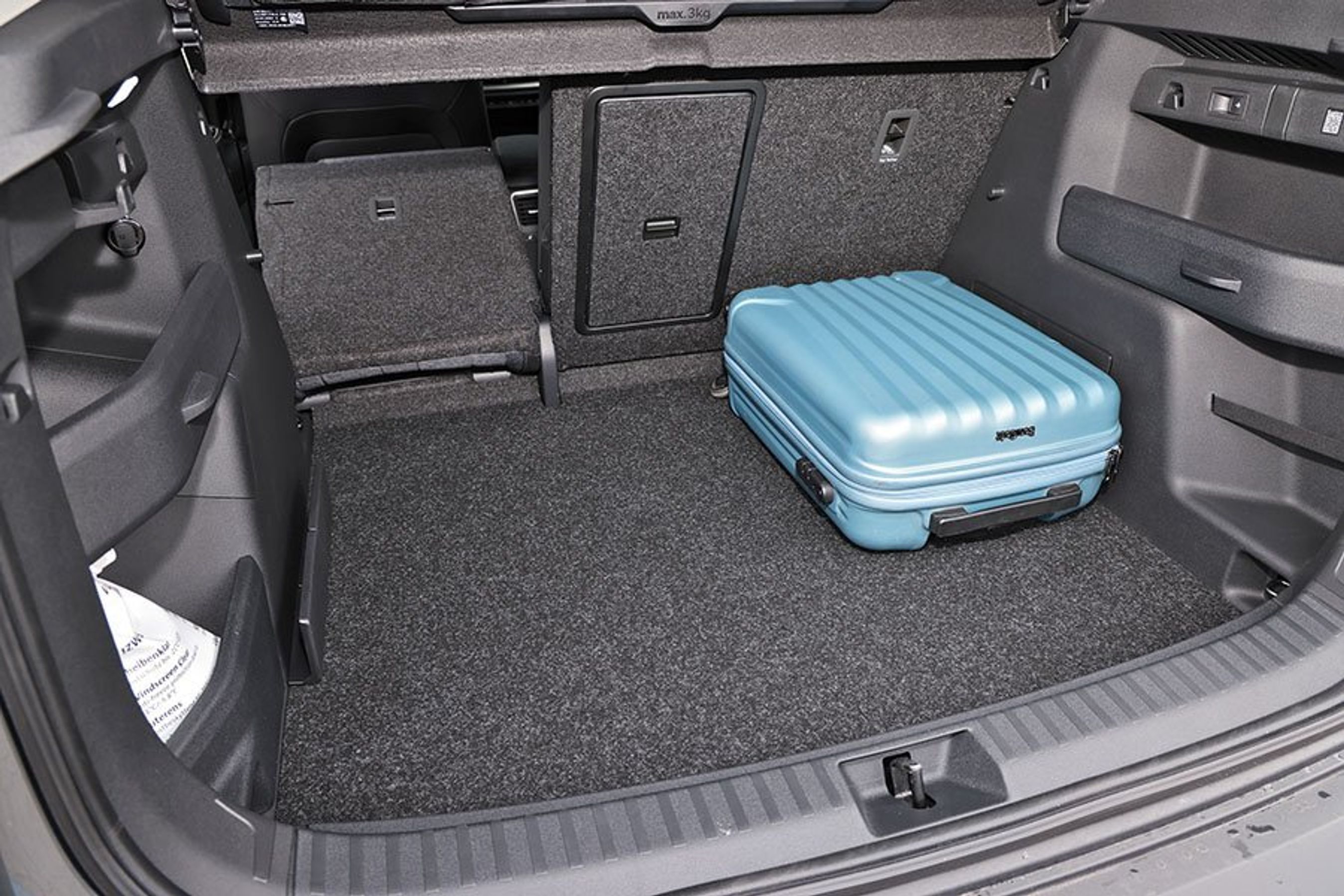 Bagagerum med blå kuffert i en Skoda Elroq