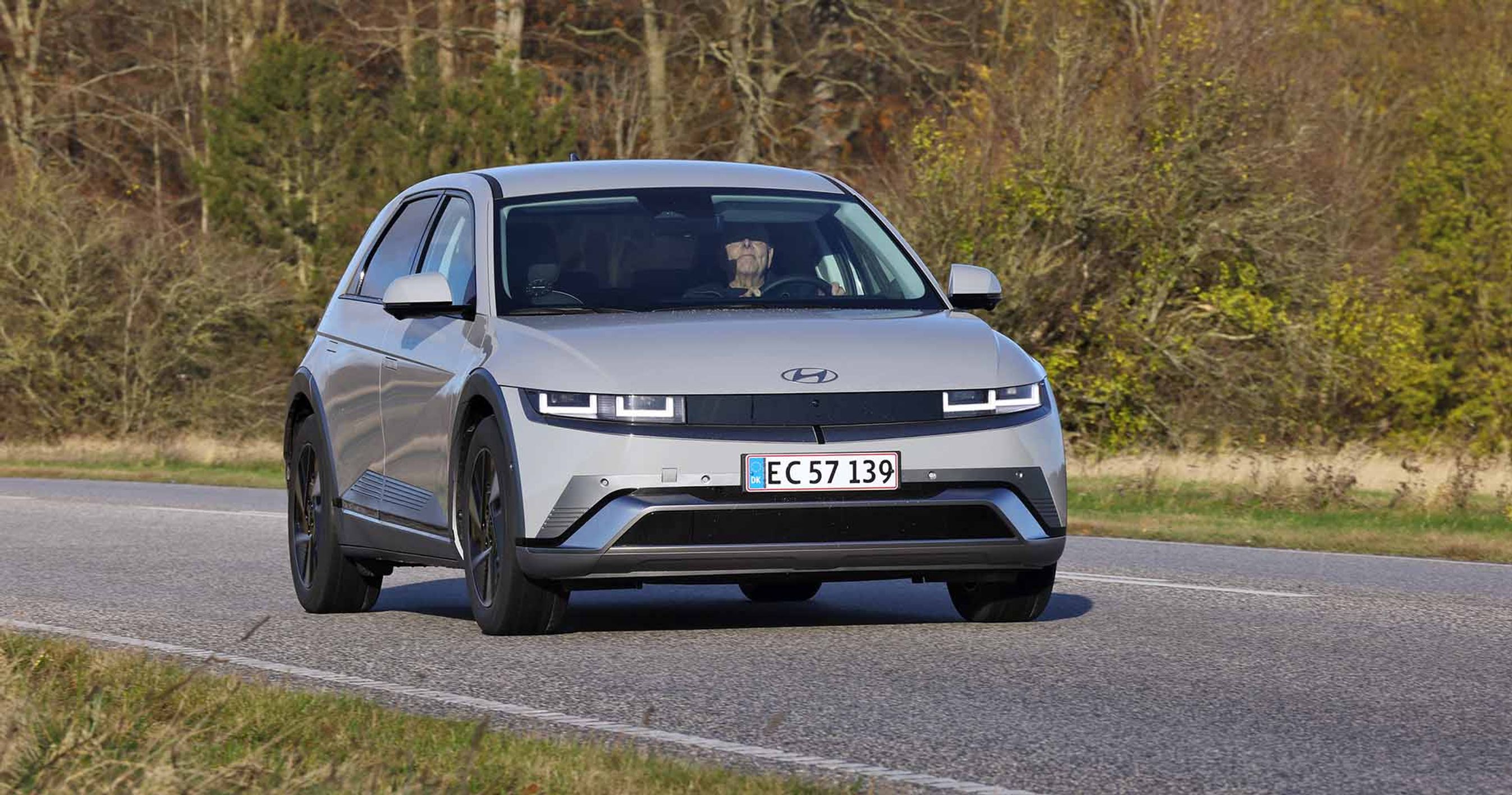 Hyundai Ioniq 5 set forfra kører på landevej med træer i baggrunden
