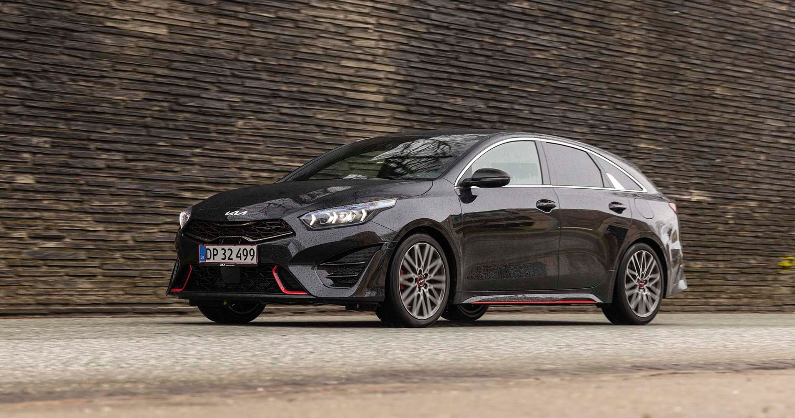 Sort Kia Proceed GT holder parkeret foran stenmur
