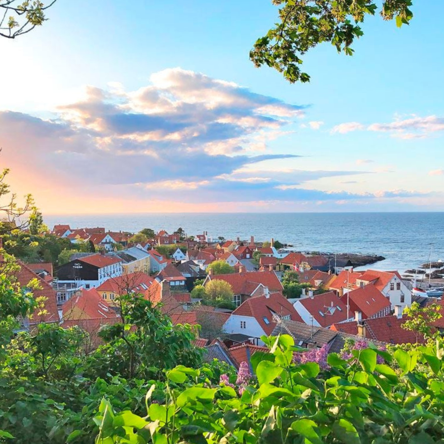 Fugleperspektiv over byen Gudhjem på fine Bornholm, hvor man kan booke og få rabatmed Team Bornholm