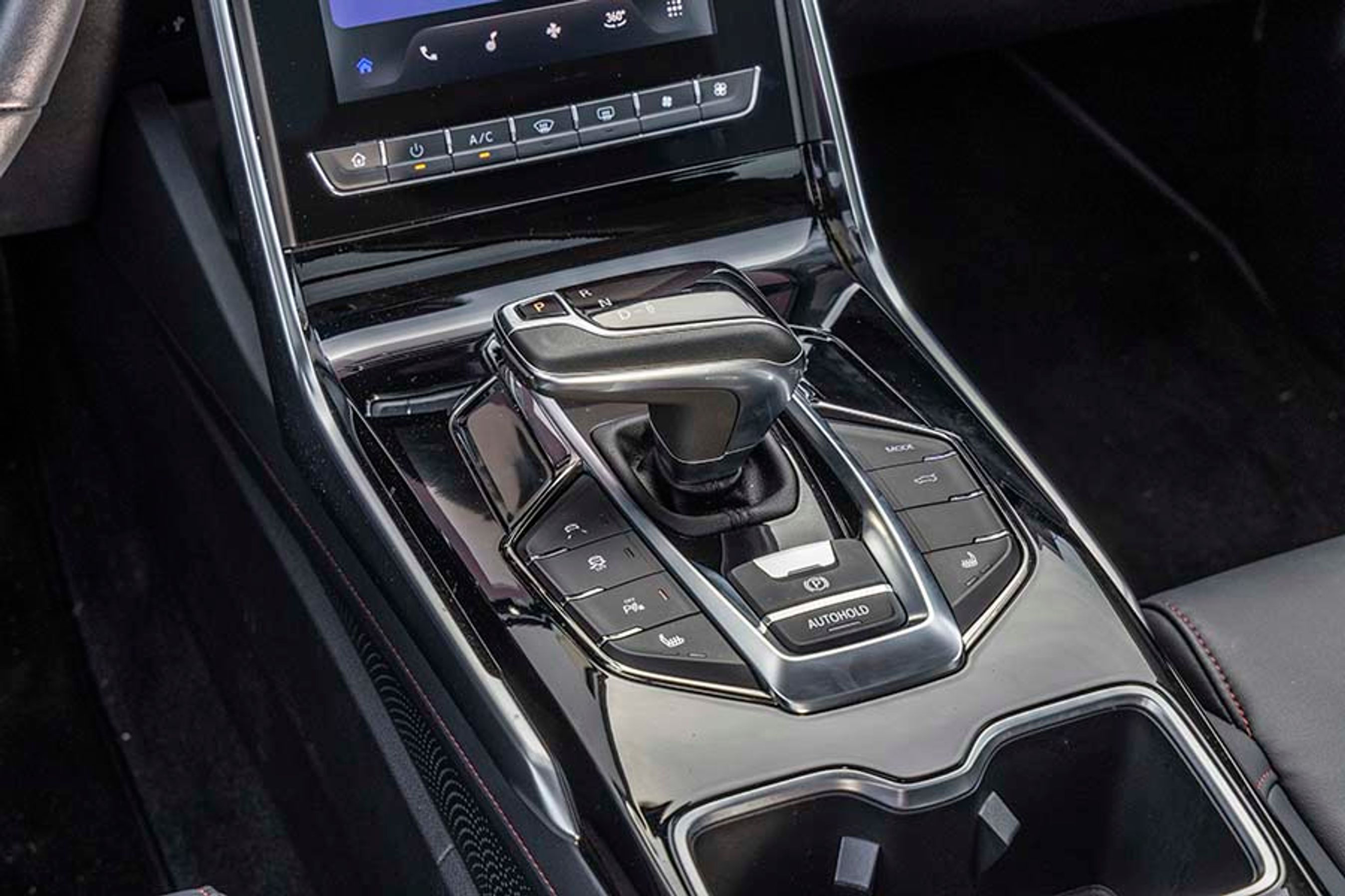 Gearvælgeren er elektronisk, er let at betjene og går selv i P, når turen er slut. To store kopholdere bag gearvælgeren er rare i hverdagen.