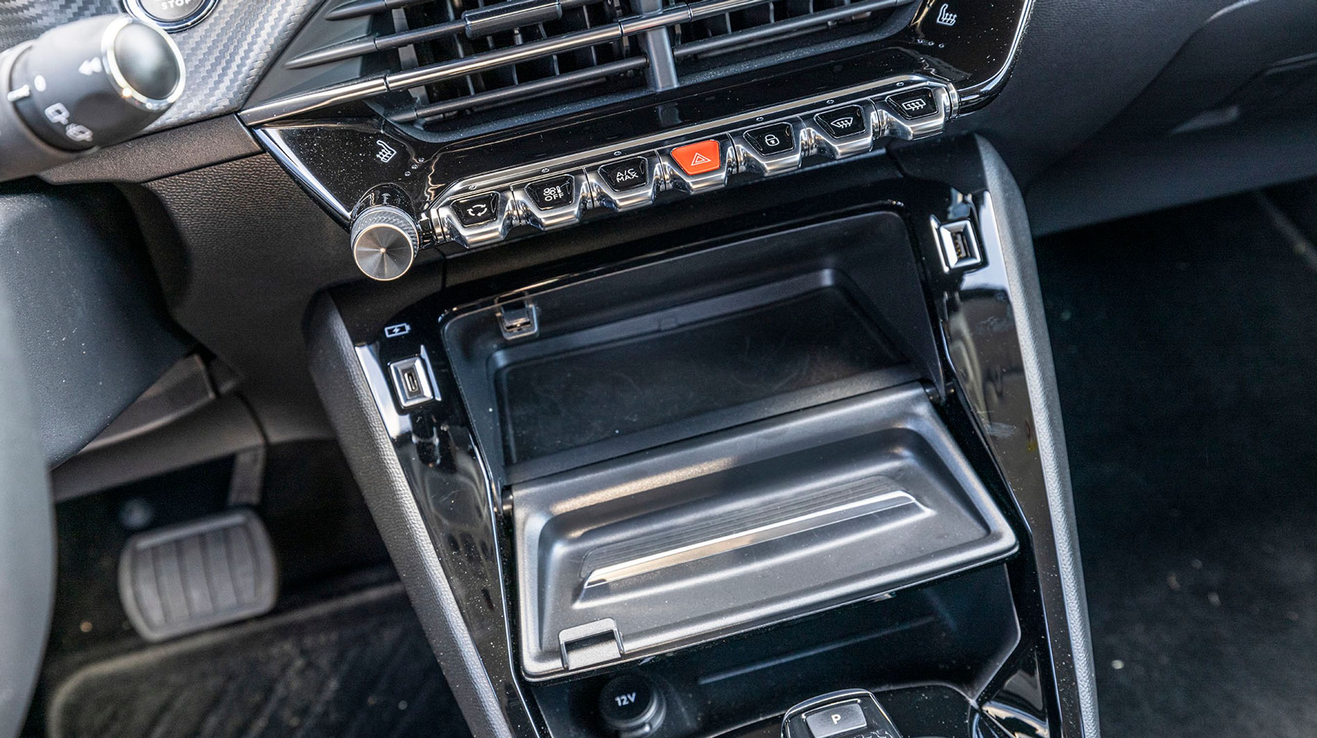 Det lille rum foran gearstangen kan åbnes med en vippeklap, der samtidig virker som hylde til mobiltelefonen. Bemærk de to typer af USB-stik.