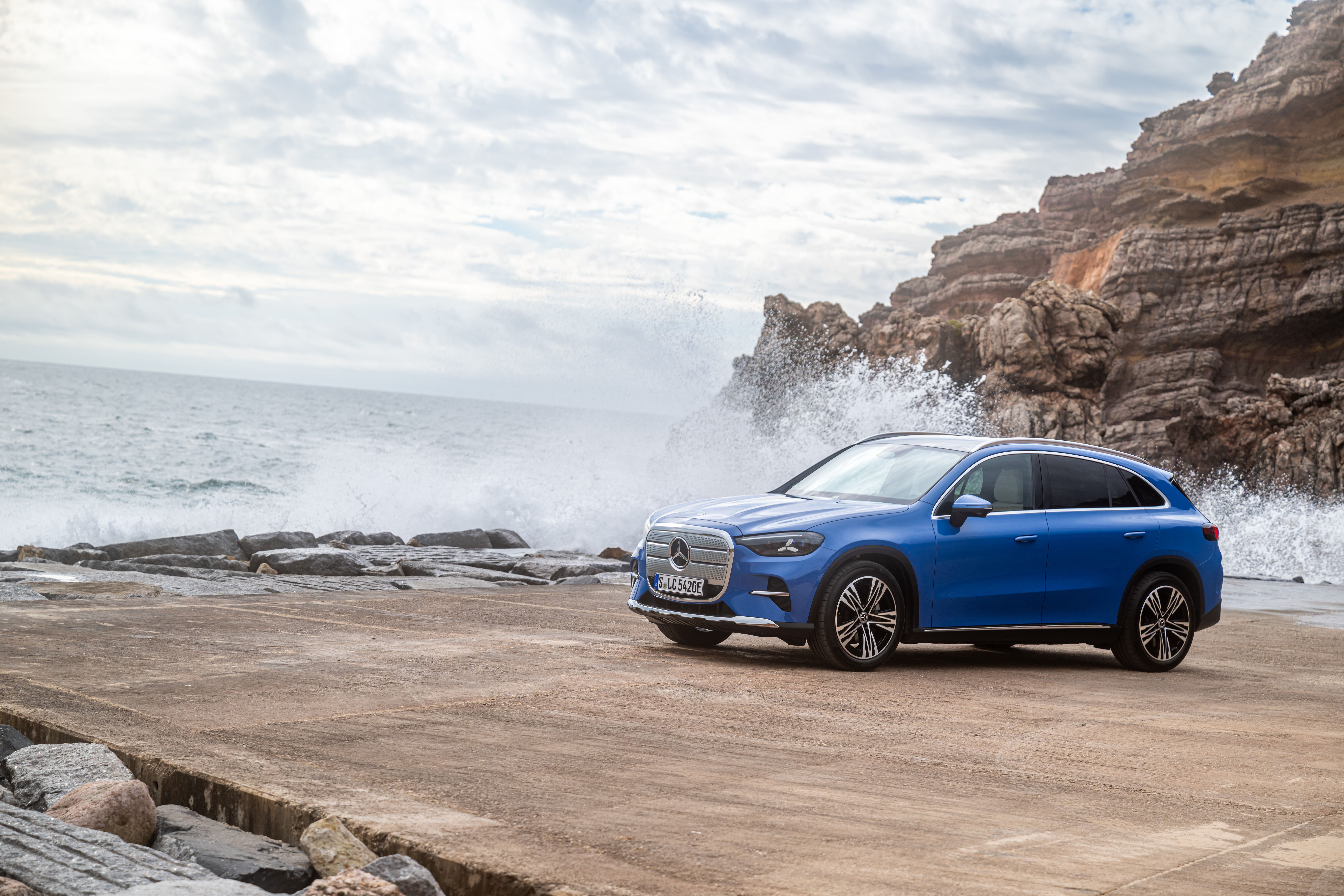 Mercedes-Benz GLC holder på klipper ved havet, emns bølger slår op