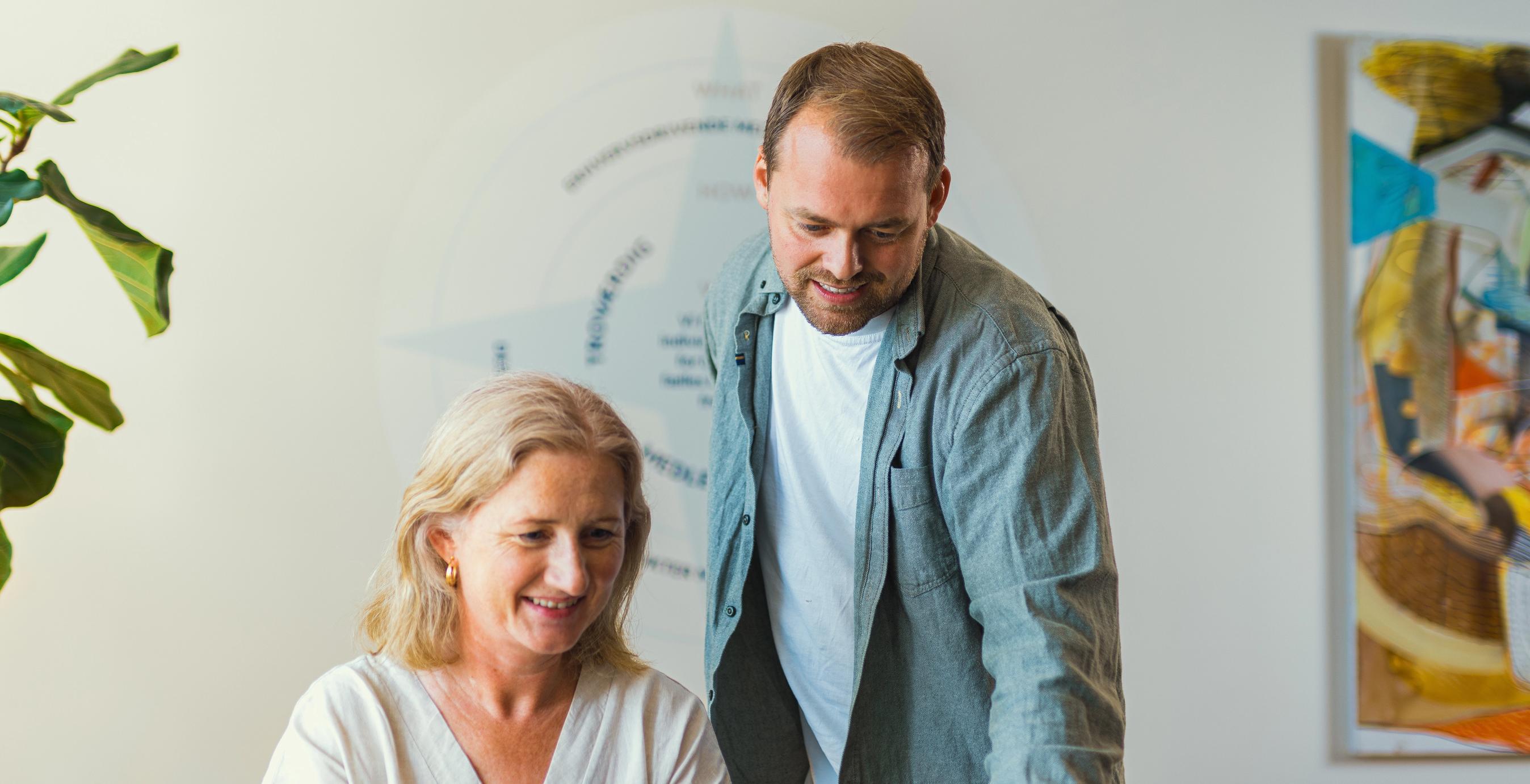 To FDM medarbejdere ser på en computerskærm