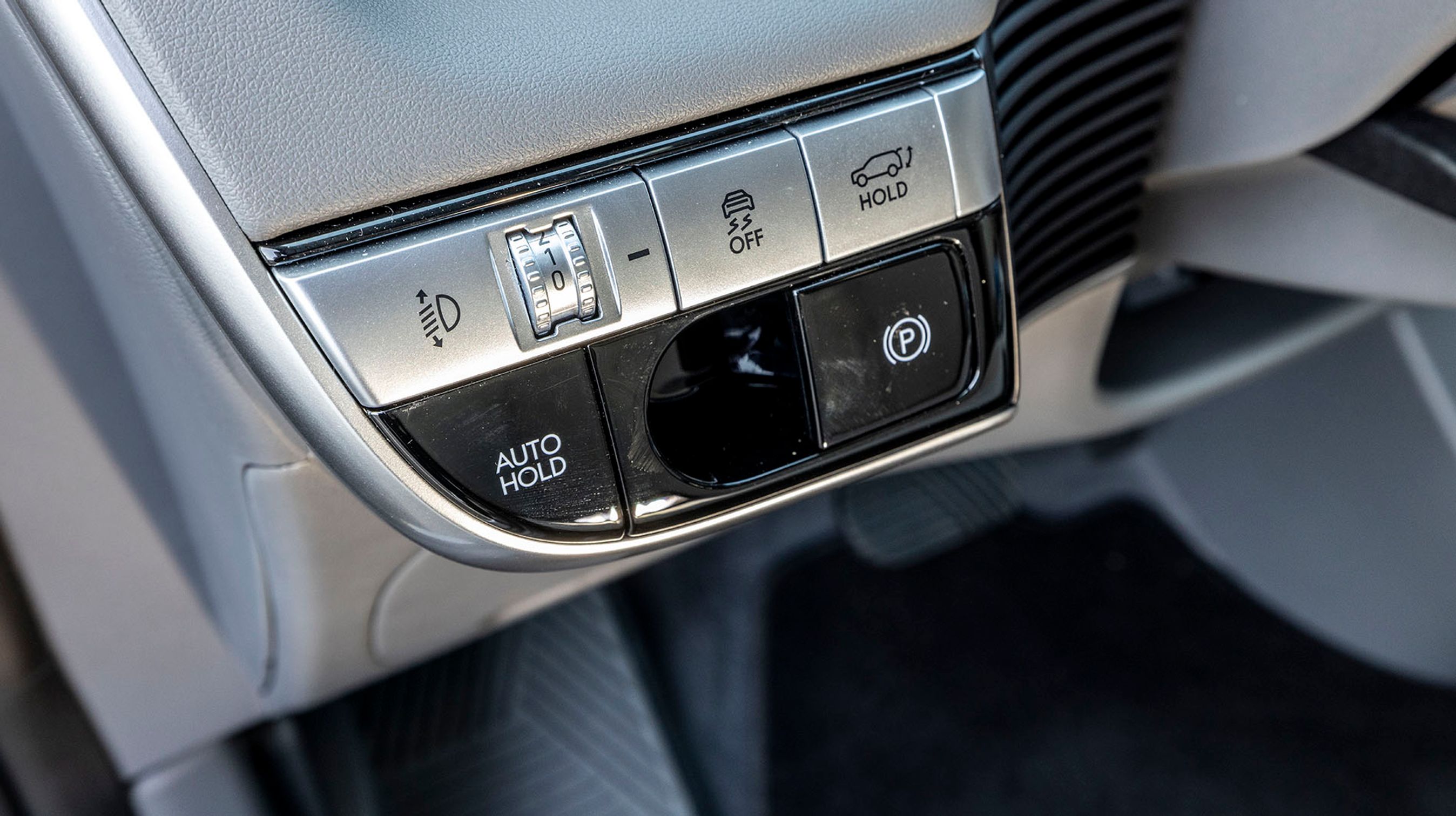 Der er LED-lygter fortil, men de er ikke udstyret med automatisk lysvidderegulering. Det klarer man manuelt med denne drejeknap til venstre for rattet.