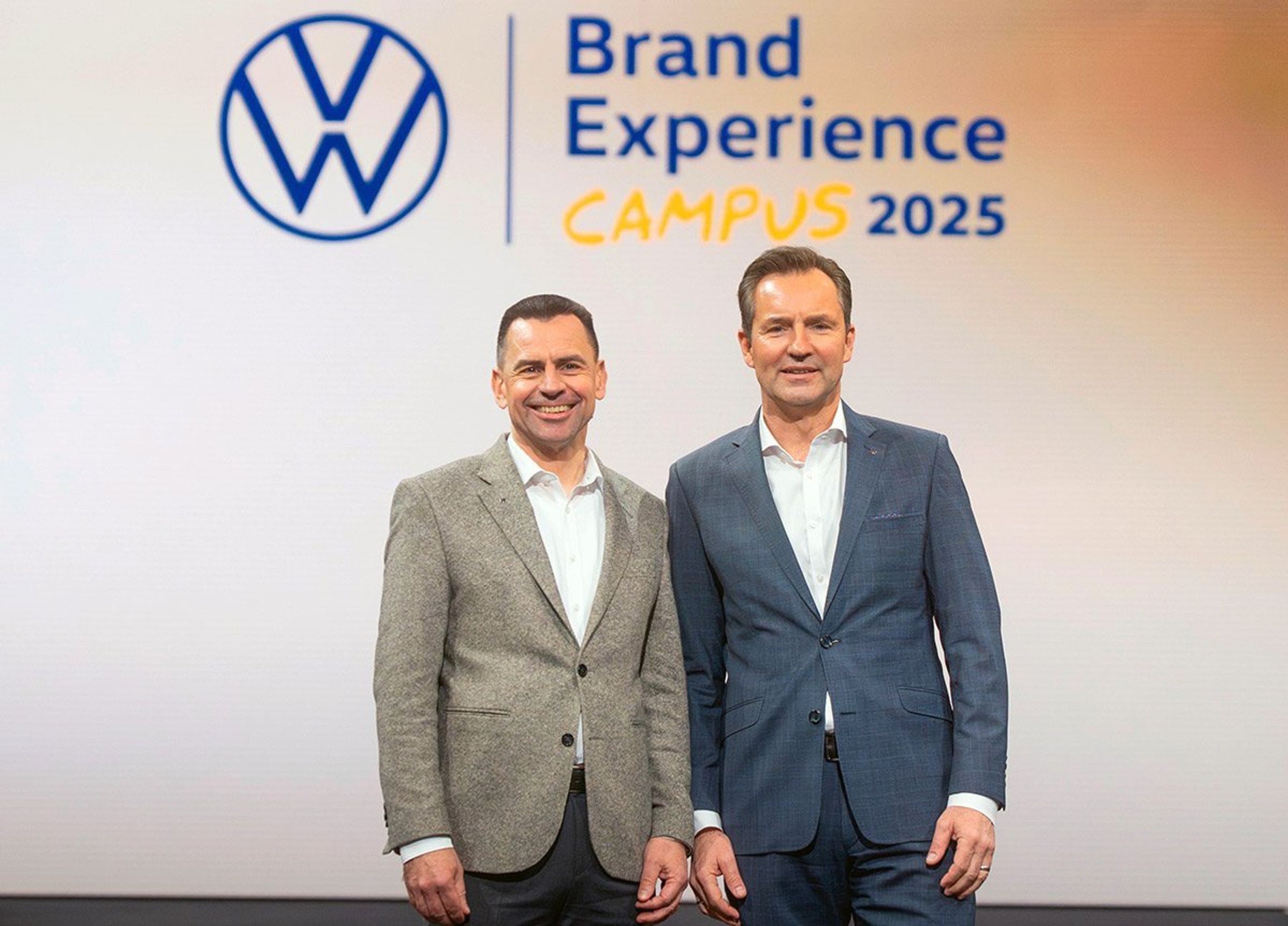 To mænd foran VW-skilt.