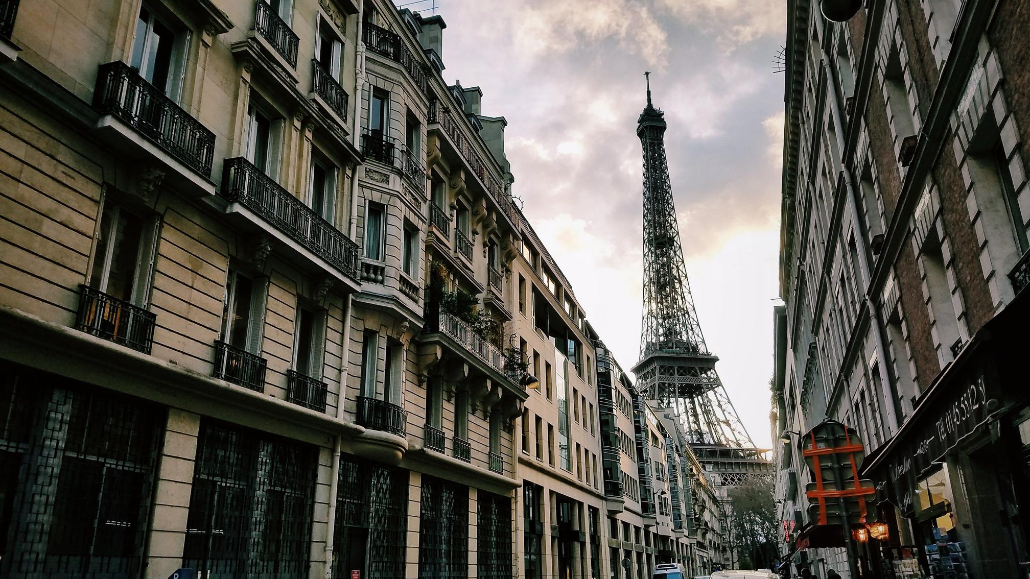 The Eiffel Tower as seen down a long street in the 7ème arrondissement, its home district