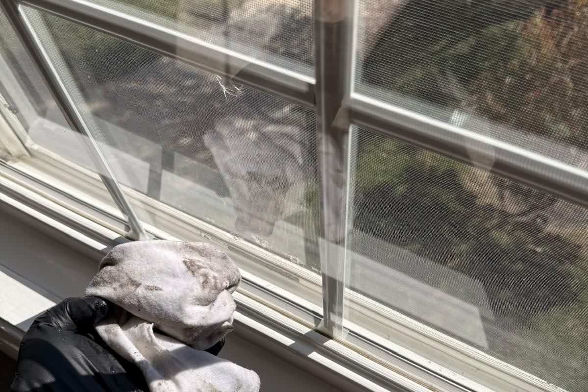 Jodec Cleaners clearing a window track by hand