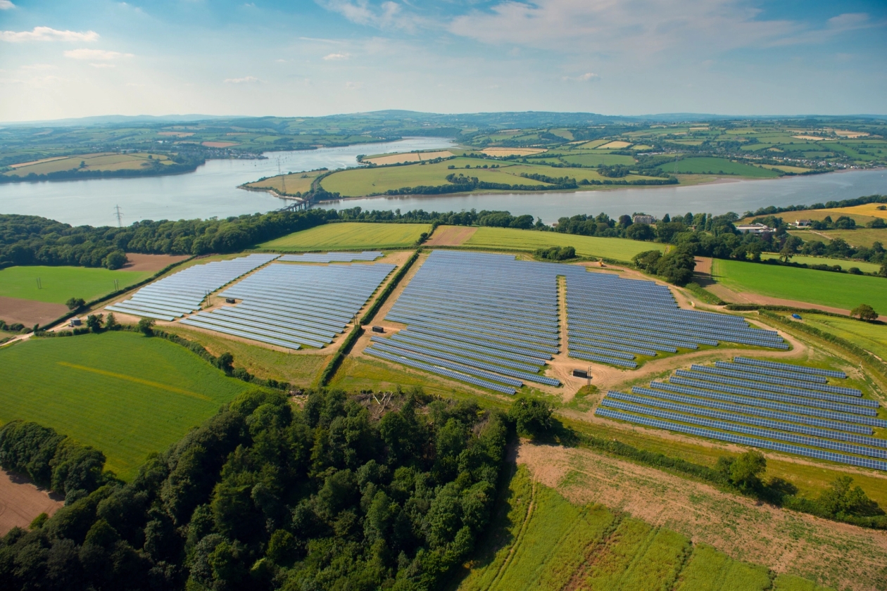 Solar farm seen from above, a river in the background