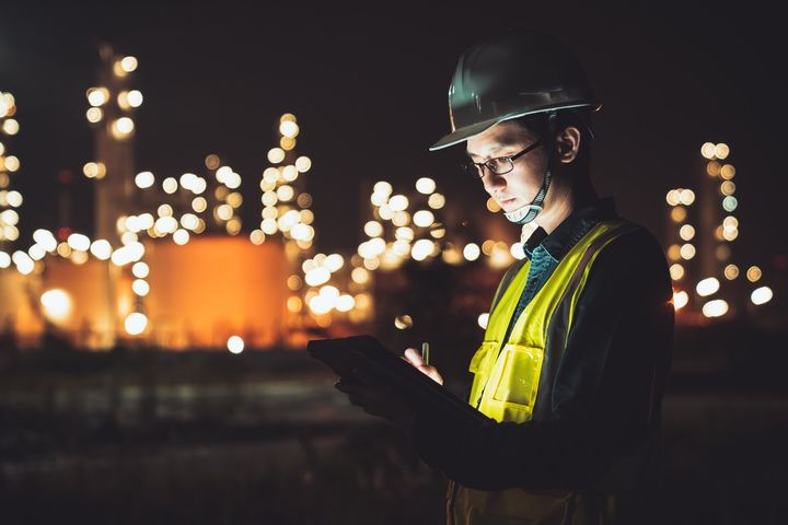 Engineer using tablet at night