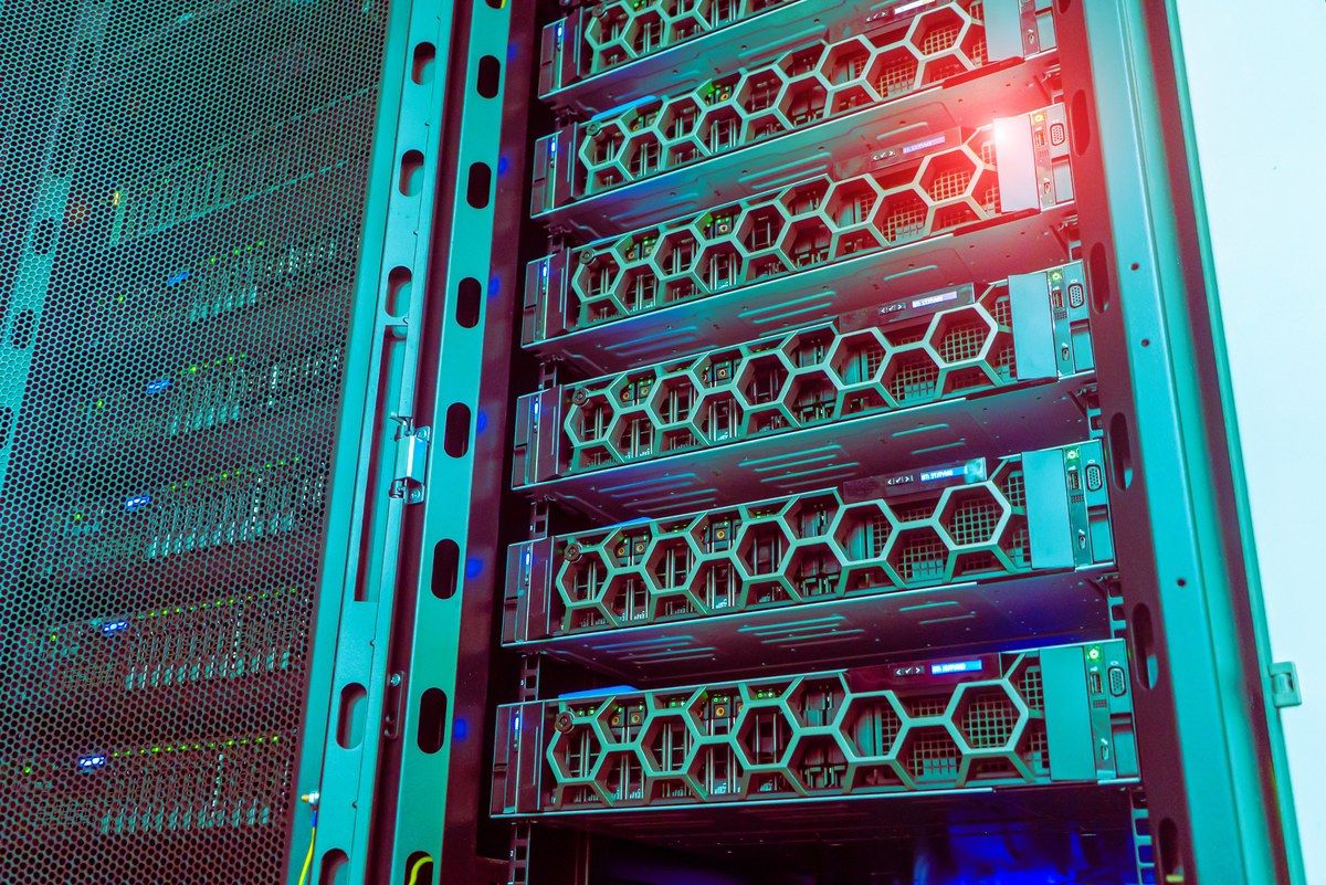 Close up of server rack units with teal lighting