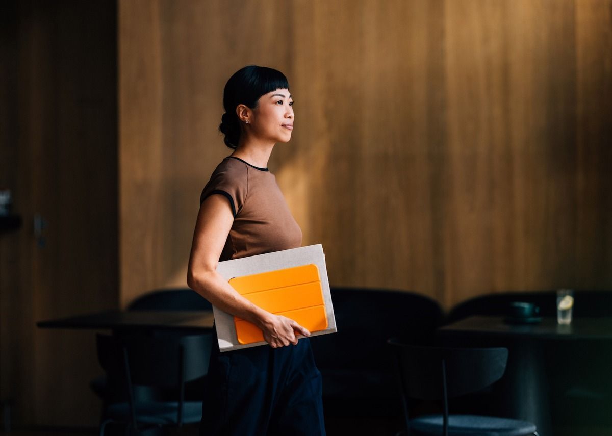 Professional woman carrying tablet in boardroom