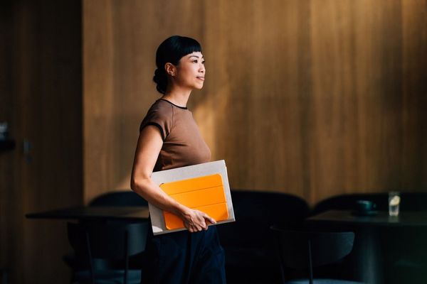 Professional woman carrying tablet in boardroom