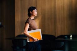 Professional woman carrying tablet in boardroom