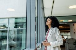Female doctor looking out window