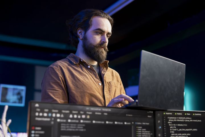 Professional working with laptop at desk