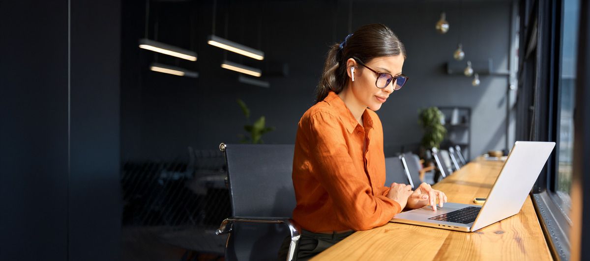 Professional working with laptop at desk