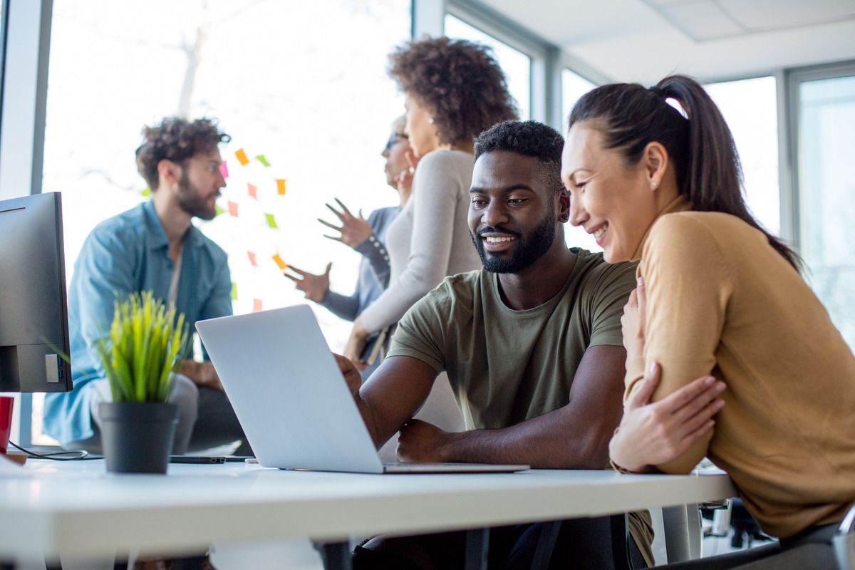 coworkers looking at laptop