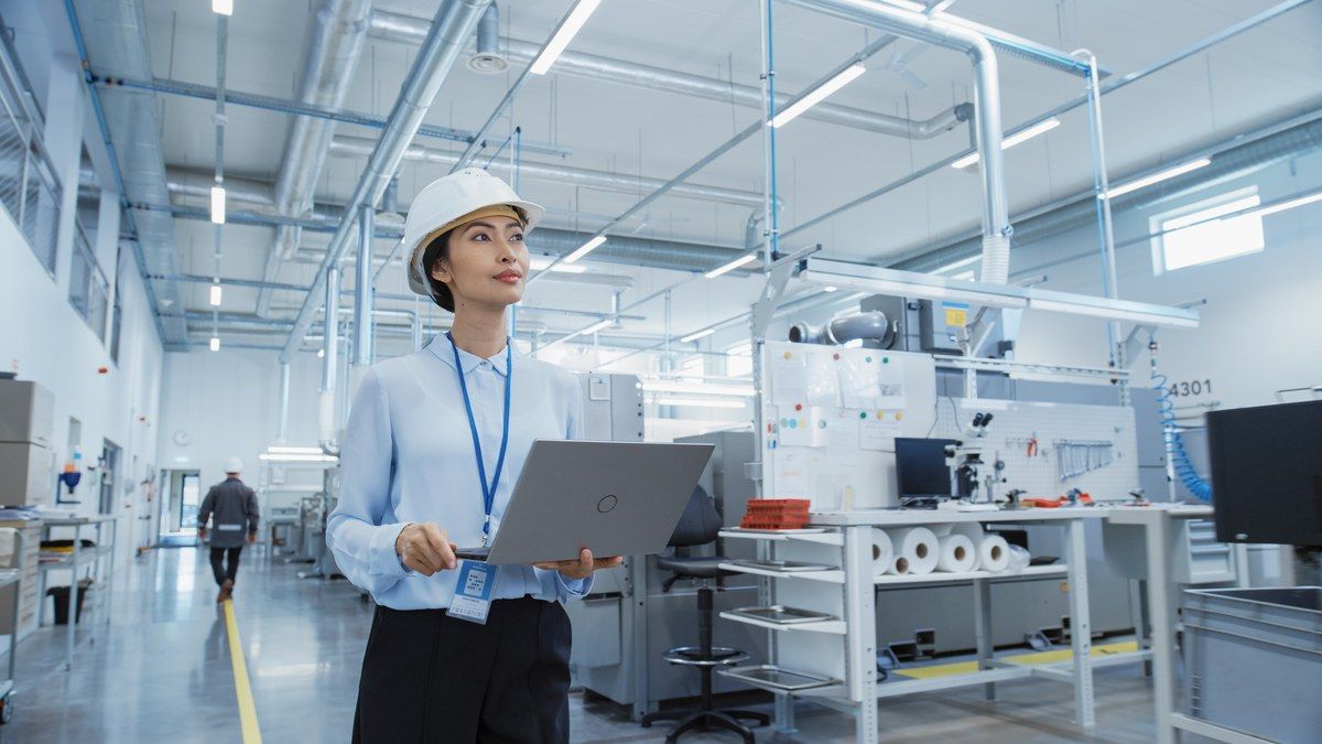 Factory worker holding laptop