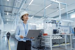 Factory worker holding laptop