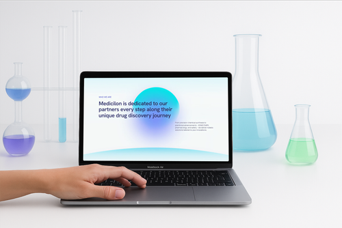 The Medicilon website on a laptop among lab glassware