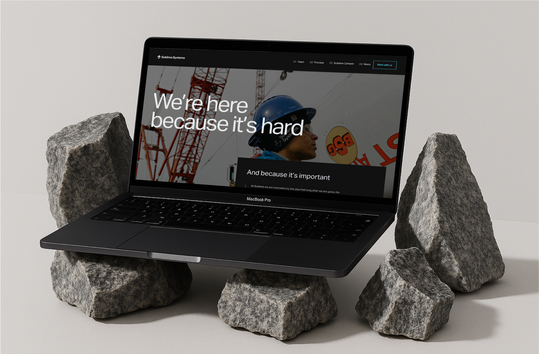 The Sublime Systems website on a laptop propped on raw rock