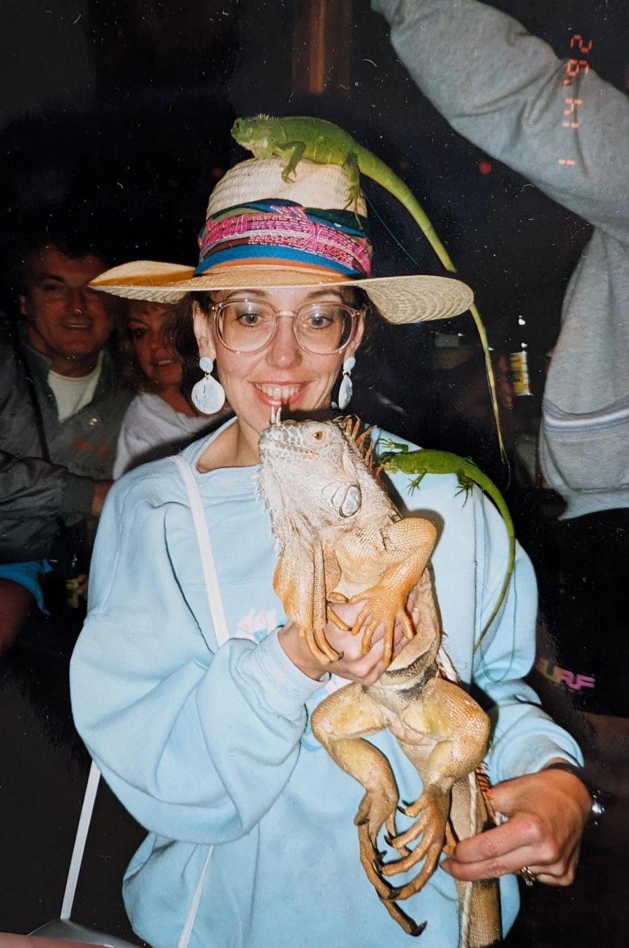 Me in the 1990s with two iguanas, one on my hat and one in my arms