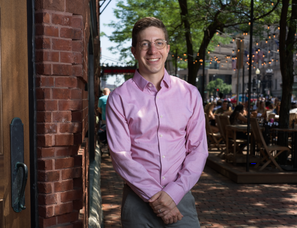 Victor wearing a pink shirt in Back Bay, Boston on the sidewalk.