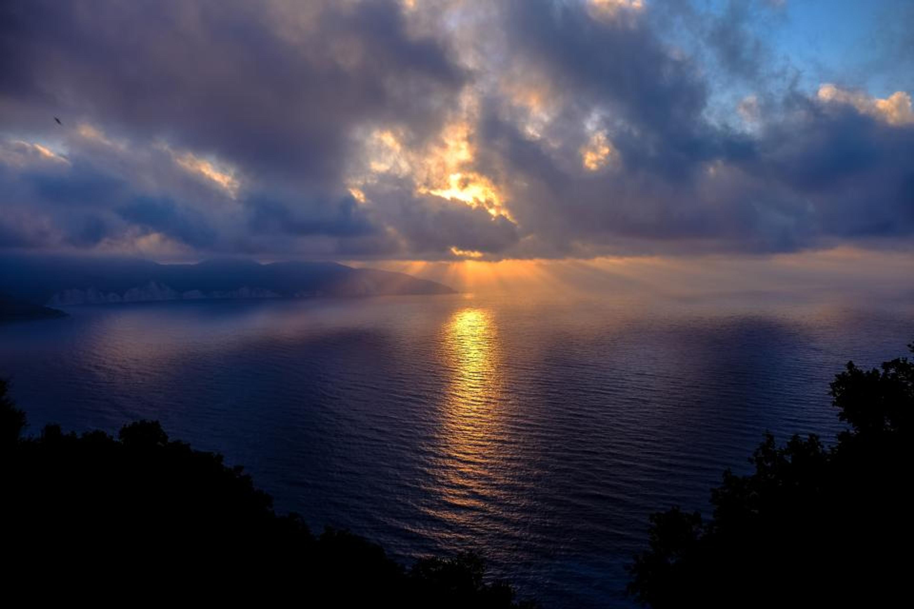 A calm sea under a soft sky.