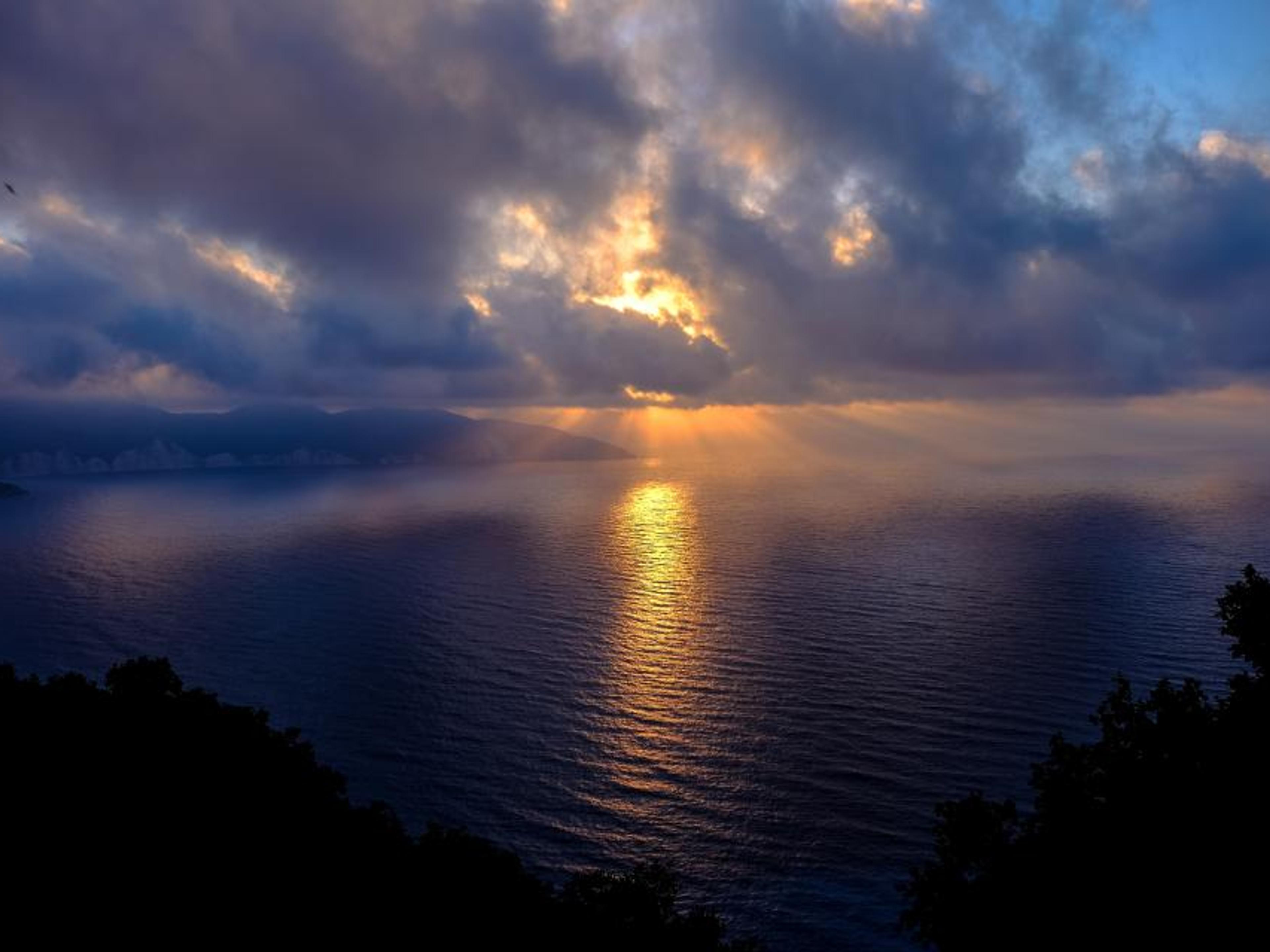 A calm sea under a soft sky.