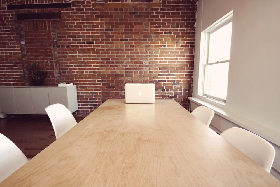 A bright workspace with a laptop and plants.