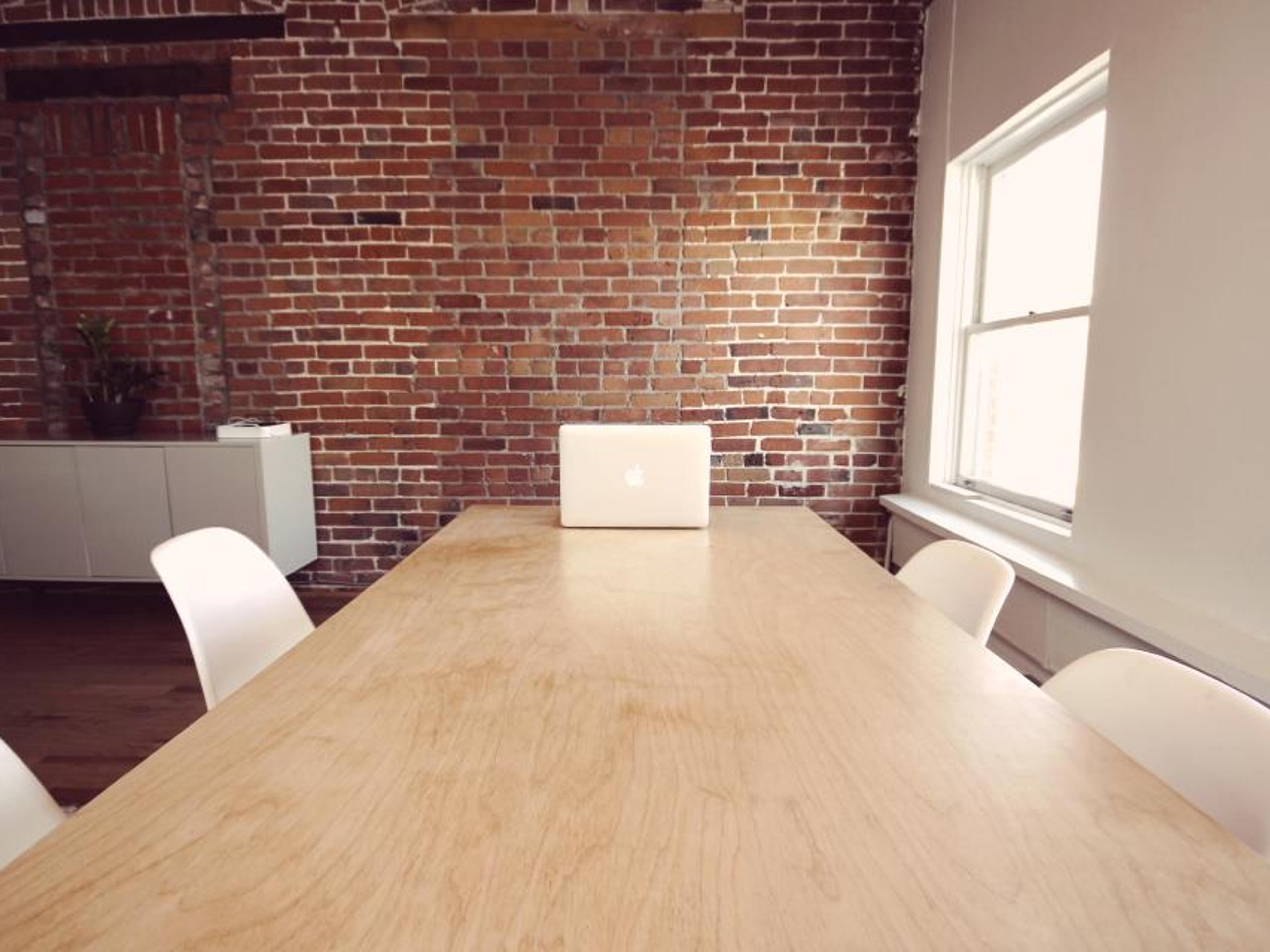 A bright workspace with a laptop and plants.