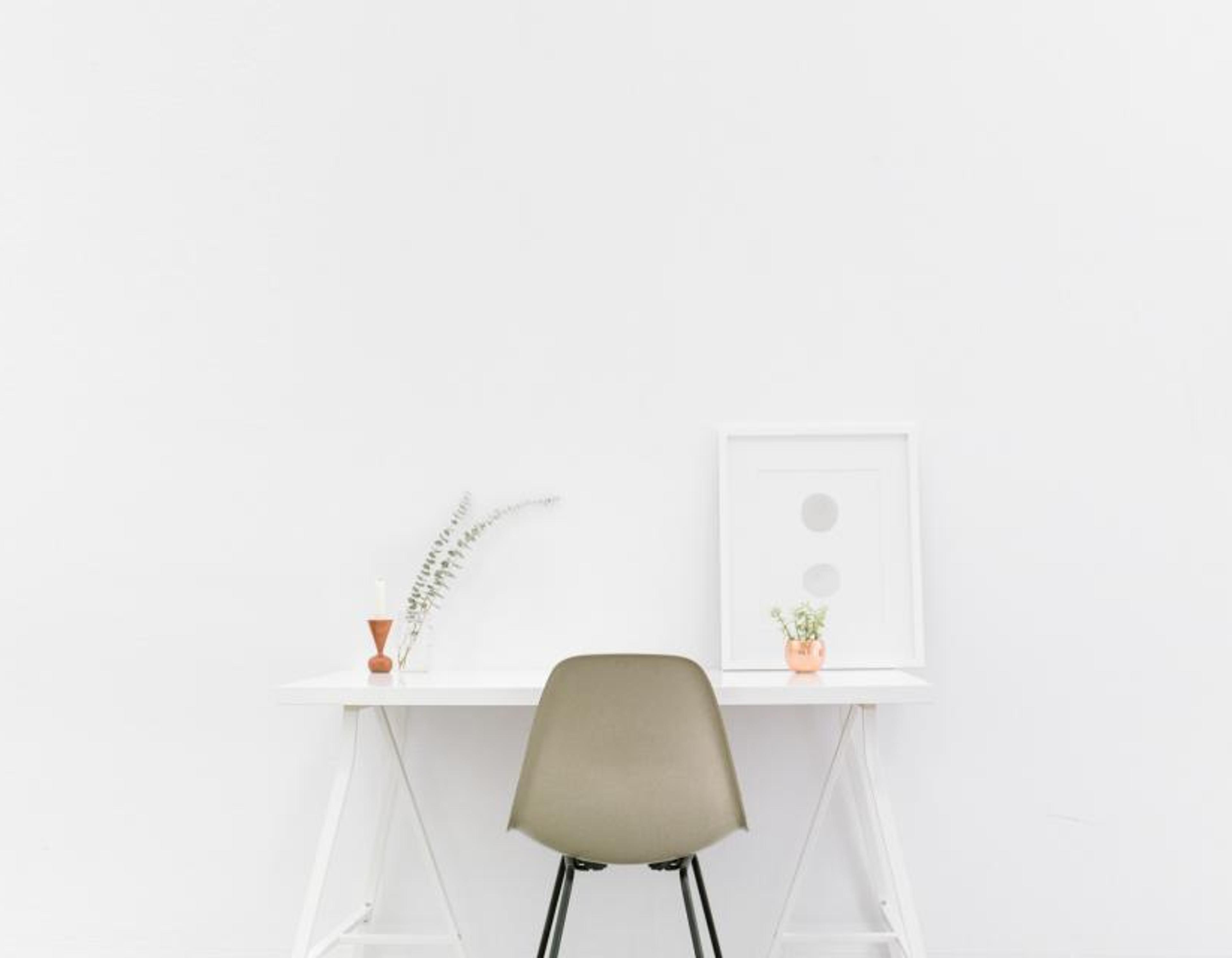 A calm, tidy office desk with a notebook and coffee.