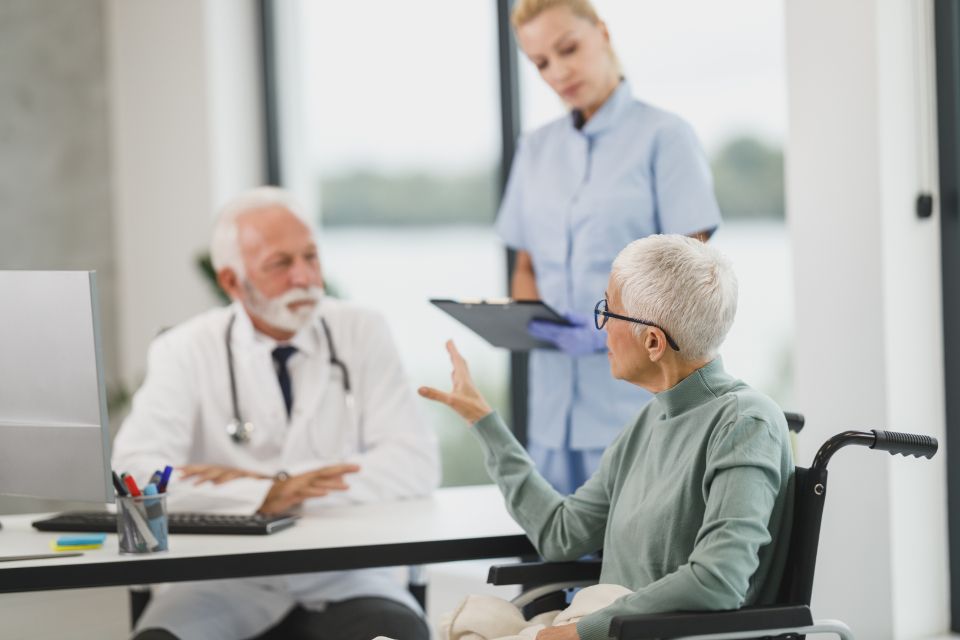 A physician reviewing notes with a patient.