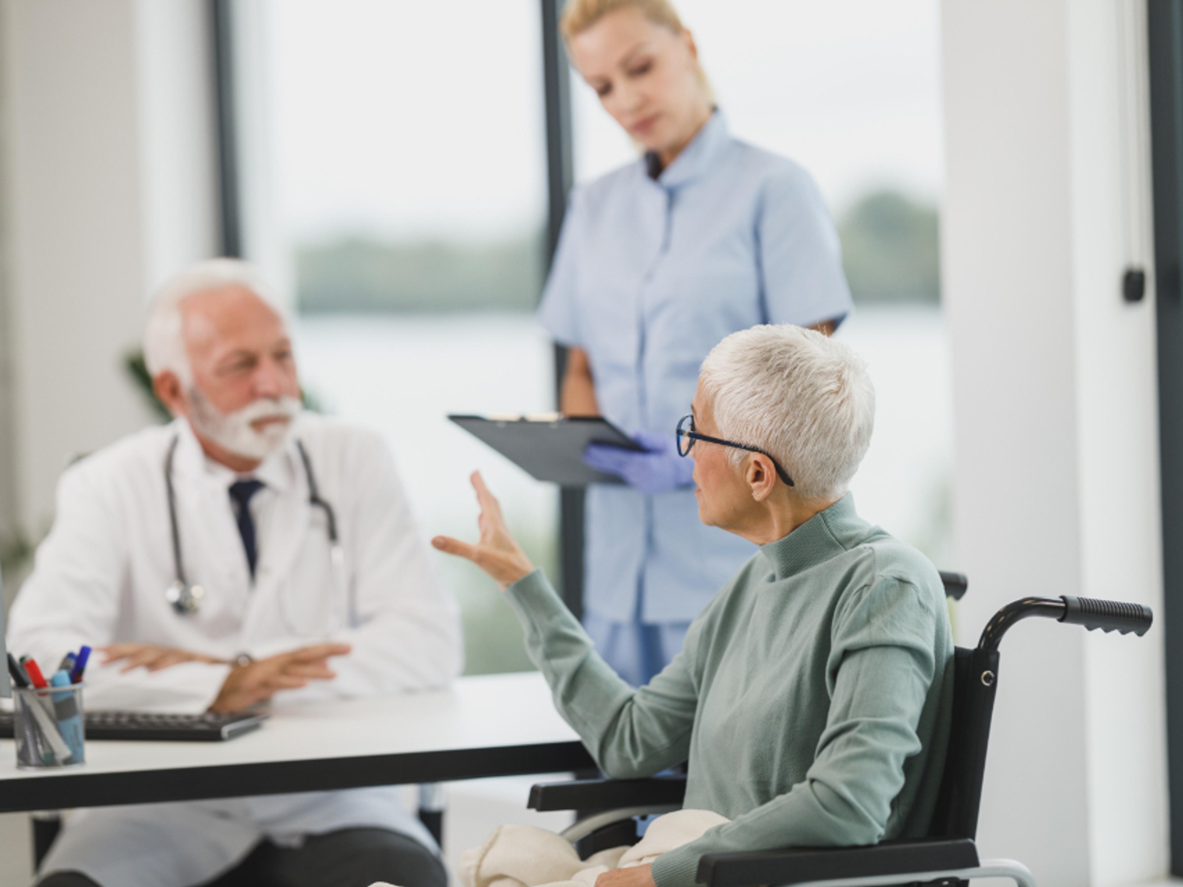A physician reviewing notes with a patient.